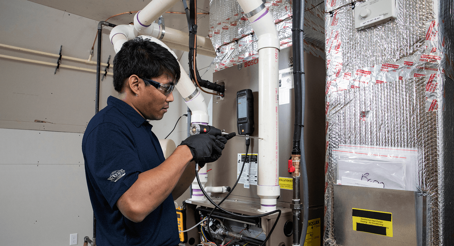 HVAC technician performing maintenance on a residential heating system.